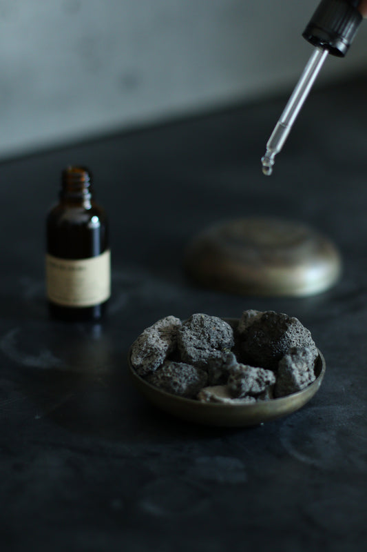 Golan Heights volcanic lava rocks with essential oil drops | סלעי לבה געשיים מרמת הגולן עם טיפות שמן אתרי