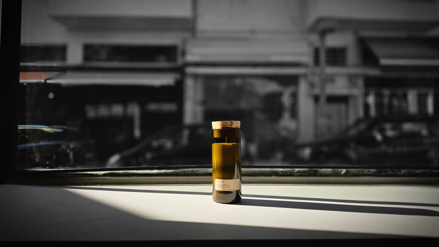 Mediterraneo Loft Botanical Candle with cork stopper in dramatic black and white window light